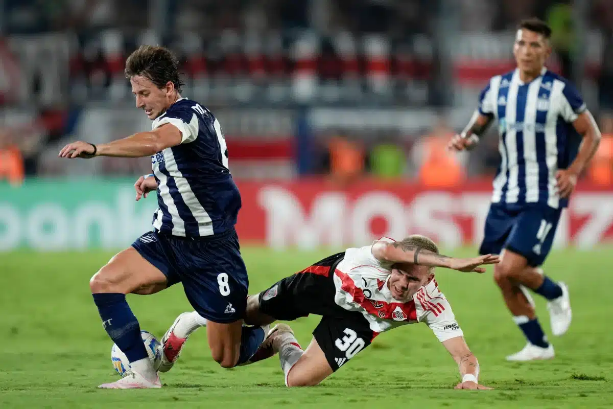 Franco Mastantuono of Argentina's River Plate, center, and Matias Galarza of Argentina's Talleres fight for the ball